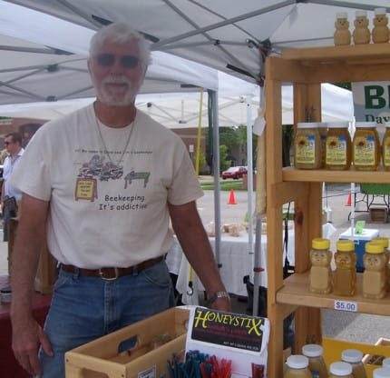 Photo by Lisa Carolin. Dave Brees at his honey booth at the Saturday Farmers Market.
