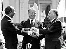 Egyptian President Anwar Sadat, left, U..S. President Jimmy Carter, center, and Israeli Prime Minister Menachem Begin clasp hands on the north lawn of the White House