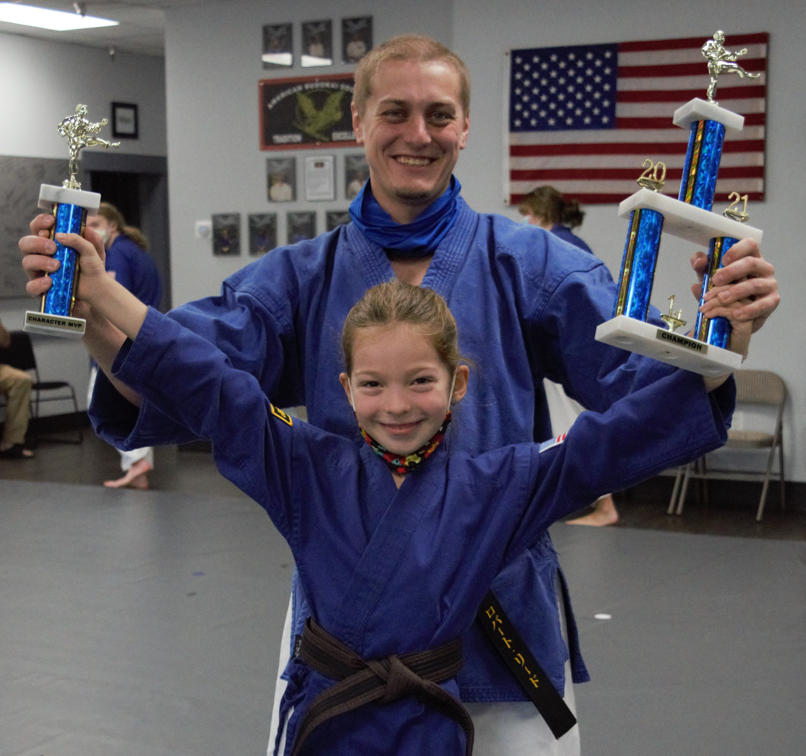 teacher and student with trophies