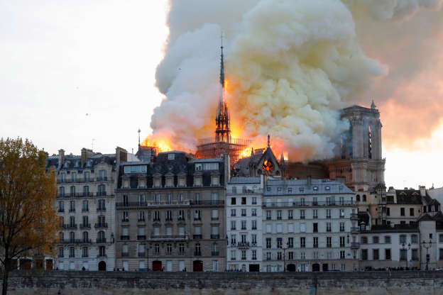 Slide 26 of 31: Seen from across the Seine River, smoke and flames rise during a fire at the landmark Notre-Dame Cathedral in central Paris on April 15, 2019, potentially involving renovation works being carried out at the site, the fire service said. (Photo by FRANCOIS GUILLOT / AFP) (Photo credit should read FRANCOIS GUILLOT/AFP/Getty Images)