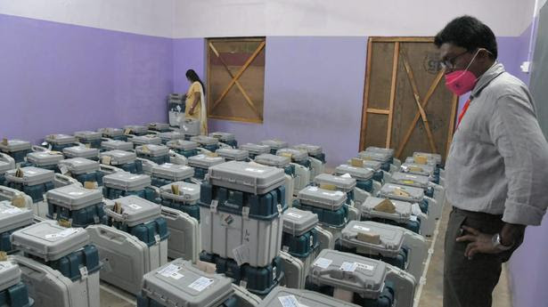 In Kerala, an officer looks at the EVMs stored in a strong room after it was opened. 