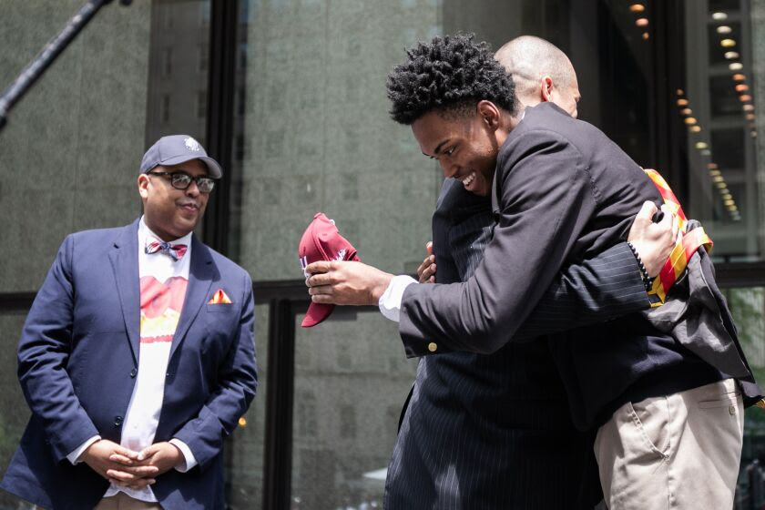 Urban Prep Academies senior Amari Austin, who was accepted at 73 different schools, celebrates with. a hug onstage during Urban Prep’s Signing Day at Daley Plaza on Thursday afternoon, May 19, 2022
