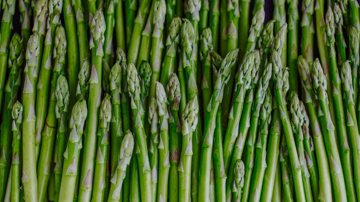 A close-up image displays asparagus.