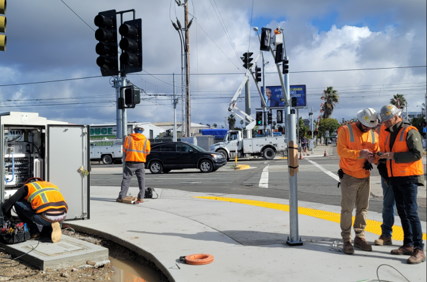 Crews prepare Cesar Chavez Parkway for the traffic signal cutover.