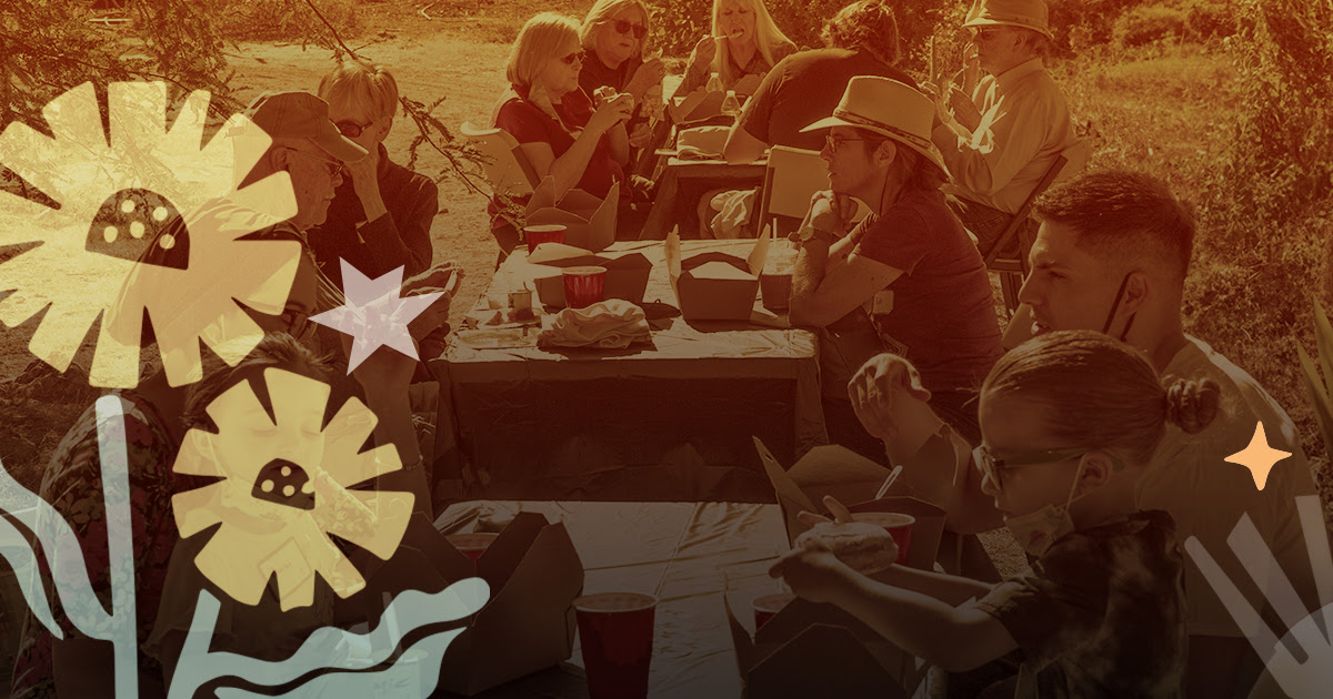 An illustrated photo of people gathered around mutiple picnic tables outside, eating and talking.