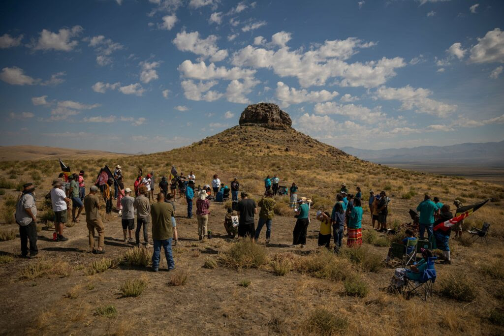 People gather for a ceremony at Sentinel Rock, at Thacker Pass, Nevada on Sunday, Sept. 12, 2021. People of Red Mountain and other Indigenous groups gathered for the ceremonial remembrance of a massacre of Paiute people near the spot on Sept. 12, 1865. Credit: Spenser Heaps