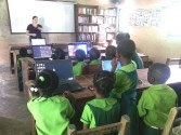 A Project TEN volunteer runs a computer class for children in a fishing village in Ghana. Photo credit: Project TEN Ghana Center Director Gonny Hyams.
