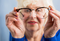 Elderly woman looking at eye glasses