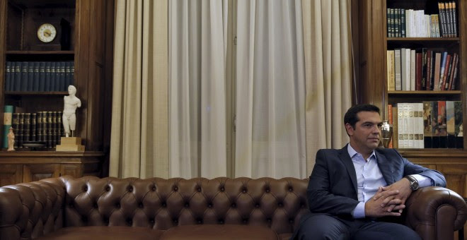 El primer ministro griego Tsipras, sentado en un sofá antes de comunicar al jefe de Estado su dimisión, en Atenas (Grecia). REUTERS