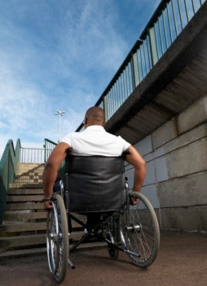 Man in wheelchair in front of steps