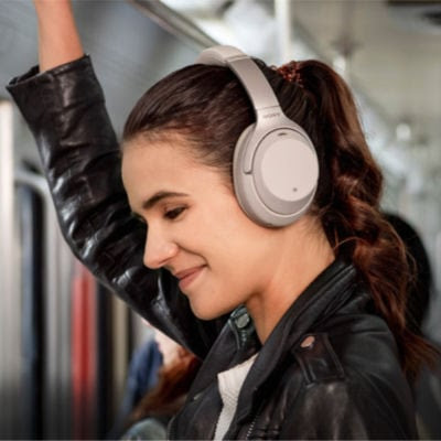 college girl using a good Christmas gift - wireless headphones