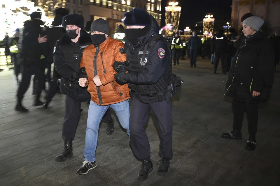 Police officer detain a demonstrator during an action against Russia's attack on Ukraine in Moscow, Russia, Thursday, Feb. 24, 2022. Hundreds of people gathered in the center of Moscow on Thursday, protesting against Russia's attack on Ukraine. Many of the demonstrators were detained. Similar protests took place in other Russian cities, and activists were also arrested. (AP Photo/Dmitry Serebryakov)