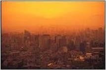 Bright yellow and orange sky over a city indicating extreme heat event. 