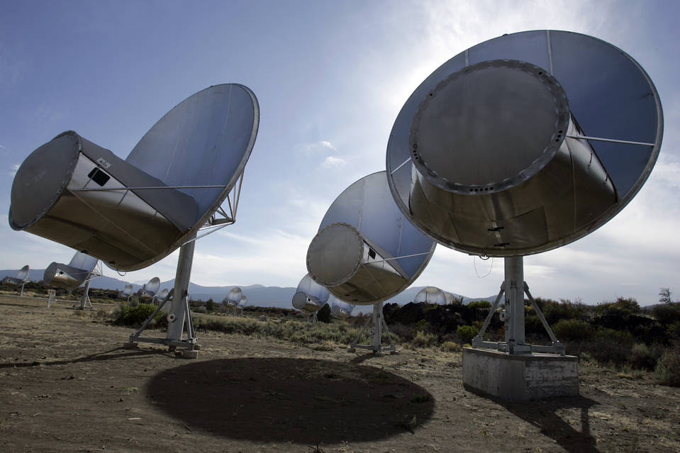In this Oct. 9, 2007 file photo, radio telescopes of the Allen Telescope Array are seen in Hat Creek, Calif. Astronomers at the SETI Institute have been forced to shutter its program that scanned the skies for signs of extraterrestrial life, saying they're out of government funds. (AP Photo/Ben Margot, File)