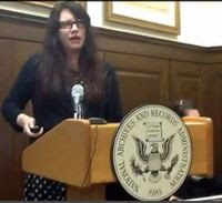 Photo of Kelly Osborn at the podium making her presentation.