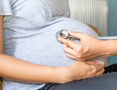 Pregnant Woman and Doctor's Hand