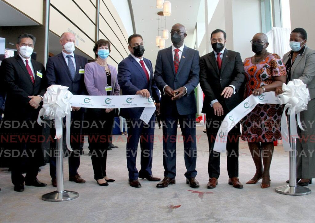 Prime Minister Keith Rowley, centre, cuts the ribbon at the launch of the Trinidad and Tobago Energy Conference with, from left, President of the National Gas Company of Trinidad and Tobago Marl Loquan, Managing Director of Proman Limited Claus Cronberger, President of BP Trinidad and Tobago Claire Fitzpatrick, Chairman of the Energy Chamber of Trinidad and Tobago Dwight Mahabir, Minister of Energy and Energy Industries Stuart Young, Housing Minister Camille Robinson-Regis and Minister of Planning and Development Pennelope Beckles during the first day of the Energy Conference at the Hyatt Regency Hotel, Port of Spain, Tuesday. - AYANNA KINSALE