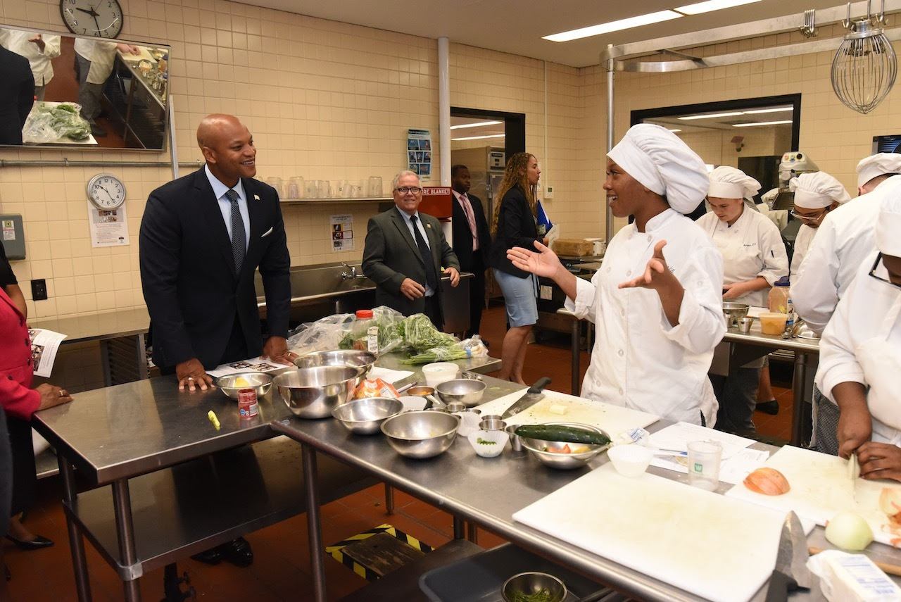 Governor Moore talking with chef in kitchen