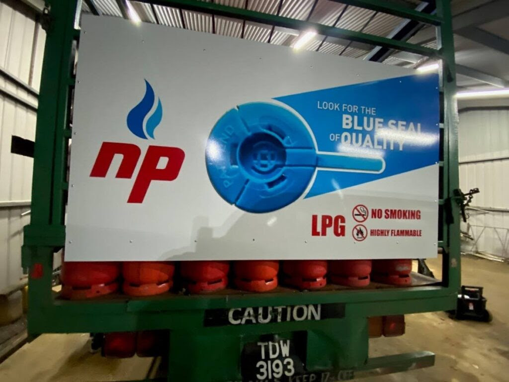 Rear view of a rebranded LPG distributor truck showcasing the NP Gas logo and the brand’s blue seal of quality. - Courtesy NP