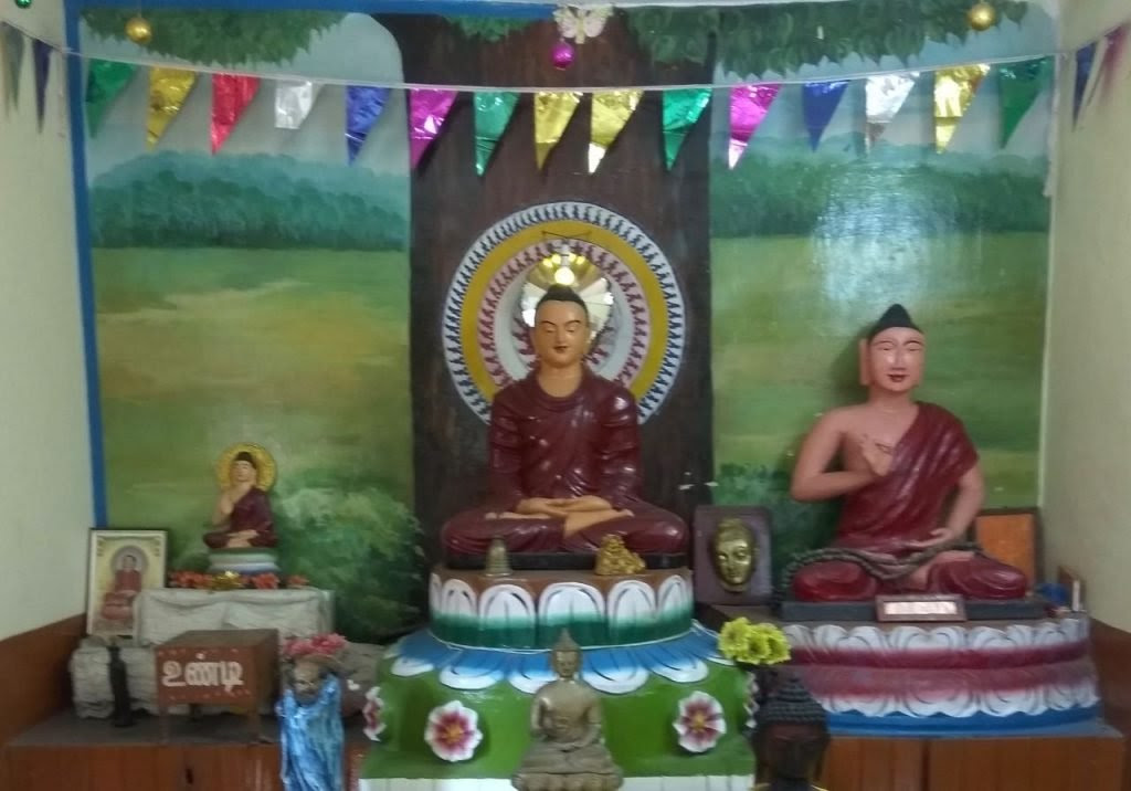 An ancient Buddha head (the right most with a new body) preserved in a new Dhamma centre at Konerikuppam, Kanchi.