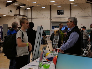 Person speaking to a teenager at a career fair