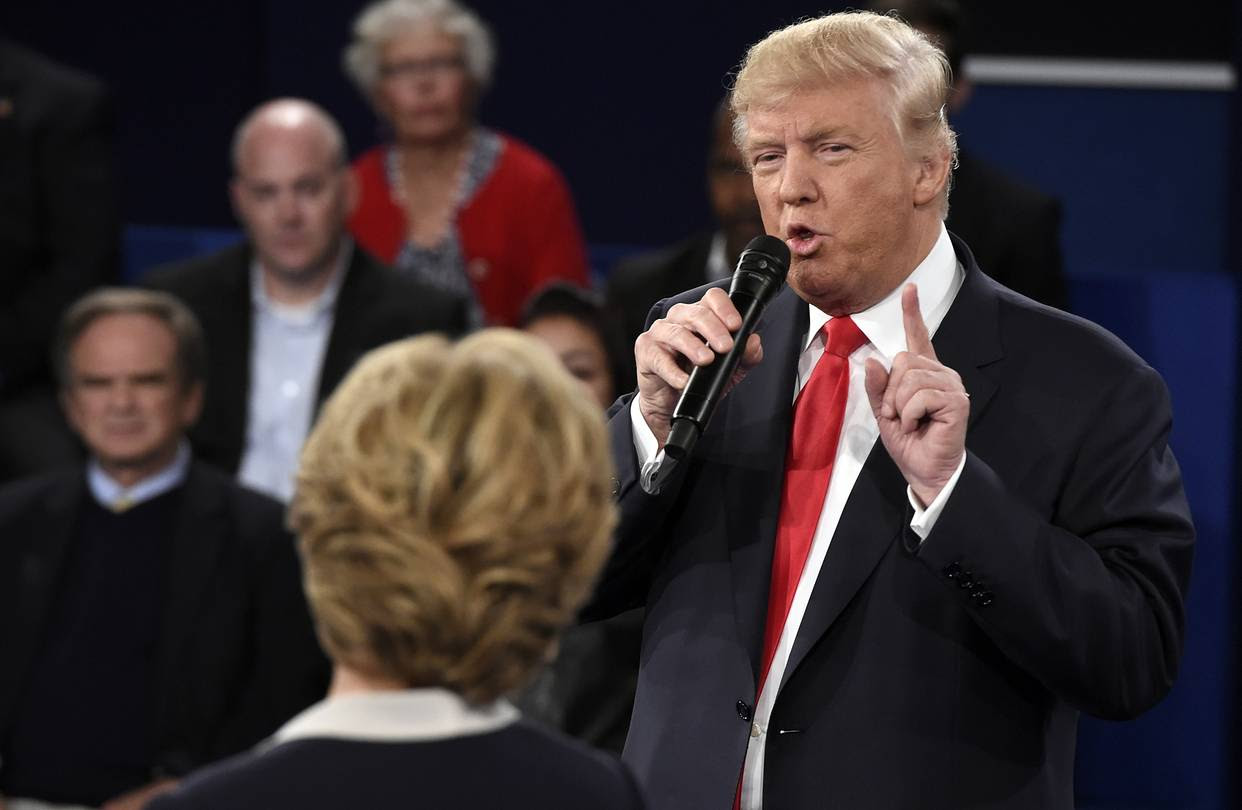 Republican presidential nominee Donald Trump speaks Democratic presidential nominee Hillary Clinton listens during the second presidential debate at Washington University in St. Louis, Sunday, Oct. 9, 2016. (Saul Loeb/Pool via AP)