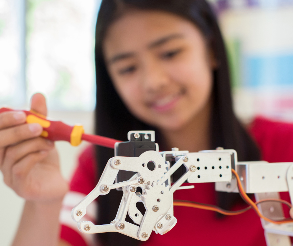 high school student working on a robot