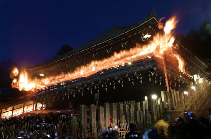 Buddhist acolytes hold giant torches over the crowd during the Otaimatsu ceremony at the temple Todai-ji. Photo by Yuta Takahashi. From aww.asahi.com