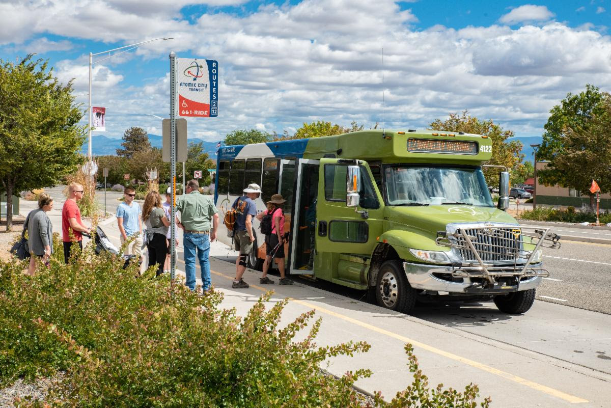 photo of passengers boarding the Bandelier shuttle bus at White Rock Visitor Center