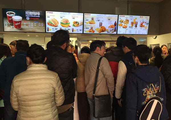 Locals form long lines in the new KFC restaurant in Lhasa, Tibet autonomous region, on March 9, its second day of business. (Palden Nyima / China Daily) 