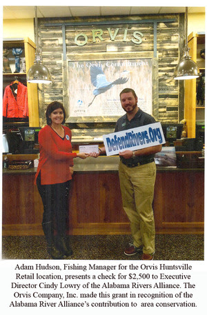 Adam Hudson, Fishing Manager for the Orvis Huntsville Retail location, presents a check for $2,500 to Executive  Director Cindy Lowry of the Alabama Rivers Alliance. The Orvis Company, Inc. made this grant in recognition of the  Alabama River Alliance’s contribution to  area conservation.