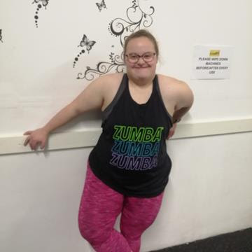 Hannah in her zumba kit leaning against a wall