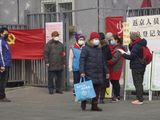 Residents wait to enter a checkpoint with a sign which reads &quot;Returnees to Beijing registration point&quot; in Beijing, China Thursday, Feb. 13, 2020. China is struggling to restart its economy after the annual Lunar New Year holiday was extended to try to keep people home and contain novel coronavirus. Traffic remained light in Beijing, and many people were still working at home. (AP Photo/Ng Han Guan)