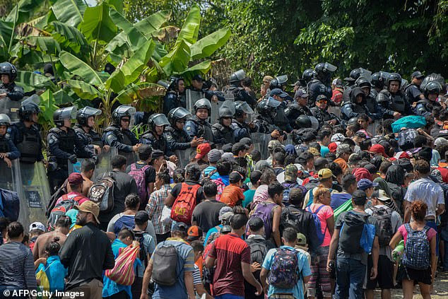 The migrants were met by hundreds of federal officers in riot g