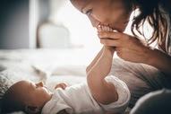 Woman kisses baby's foot
