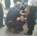 Police standing over a captured Arab terrorist in Tel Aviv.