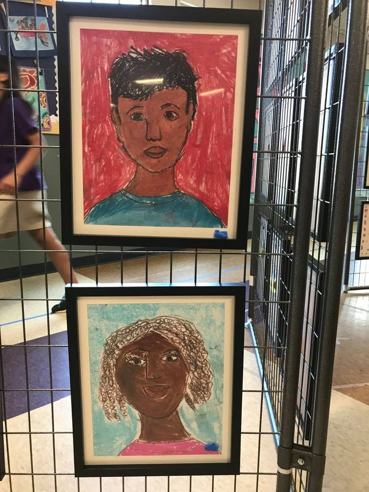 self portraits of GVA DC students hung up to display