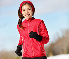 Smiling woman running outside.