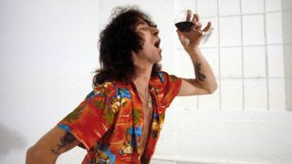 Bon Scott, posed, studio, drinking glass of wine