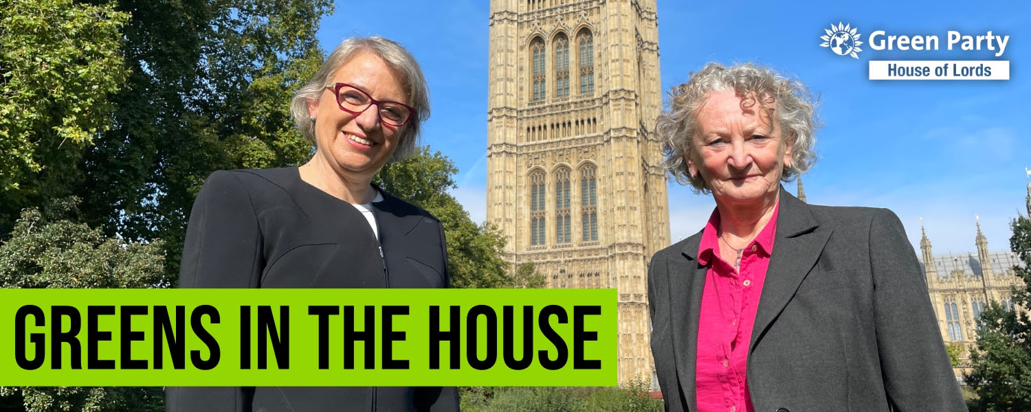 Photo of Natalie Bennett and Jenny Jones outside Parliament with text that reads:   Greens in the House.   With Green Party House of Lords logo in top right.