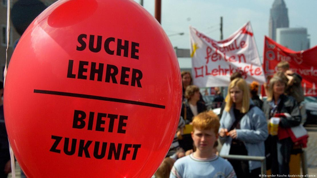 Balão com a frase "procuro professor, ofereço futuro" durante protesto do setor da educação em Frankfurt.