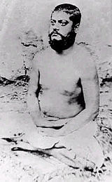 Image of Vivekananda, sitting in meditative posture, eyes opened