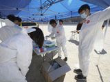 Paramedics put on protective gear to inspect people possibly infected with the coronavirus in Daegu, South Korea, Sunday, Feb. 23, 2020. South Korea&#39;s president has put the country on its highest alert for infectious diseases and says officials should take &quot;unprecedented, powerful&quot; steps to fight a viral outbreak. (Kim Hyun-tai/Yonhap via AP)