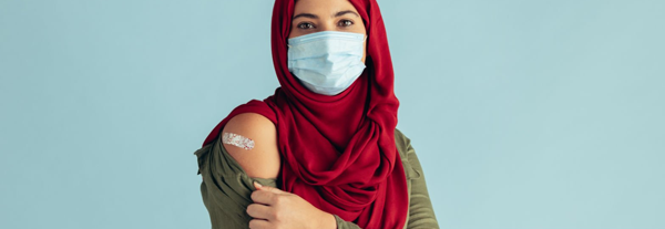 Muslim woman showing she was recently vaccinated