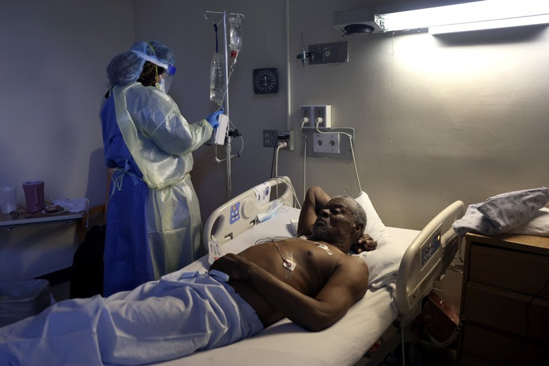 A nurse treats a patient with Remdesivir in hospital