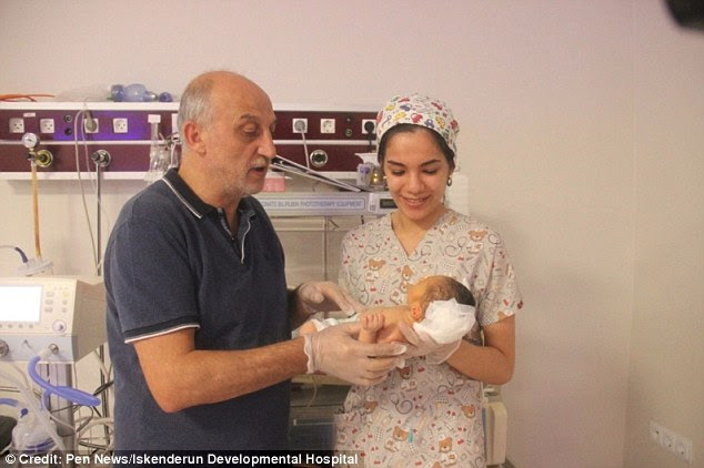 Abdullatif's mother Sana Hilel (pictured with Dr Mehmet Koparan, who performed the surgery), of Aleppo, decided to cross the Turkish border to have her seventh child by C-section
