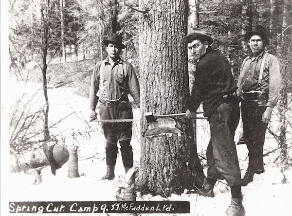vintage lumberjacks using ax to chop tree