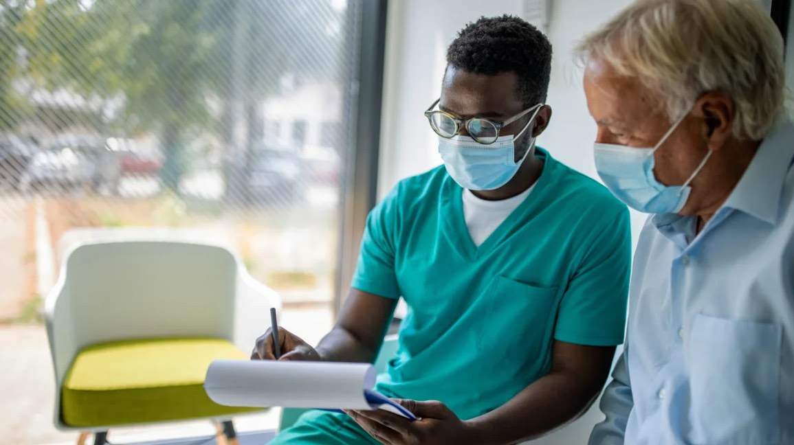 A physician speaks to a patient.