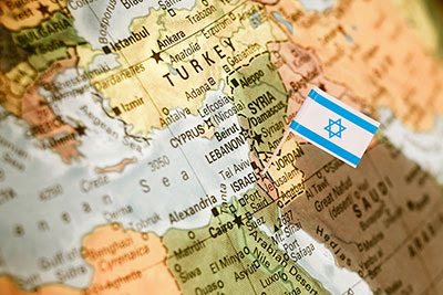 Israeli flag on globe of world marking state of
              Israel.