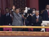 Chinese President Xi Jinping, center, waves next to former President Hu Jintao, right, during a ceremony to mark the 100th anniversary of the founding of the ruling Chinese Communist Party at Tiananmen Gate in Beijing Thursday, July 1, 2021. (AP Photo/Ng Han Guan)